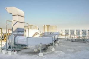 The industrial machine at the rooftop of the huge building. photo