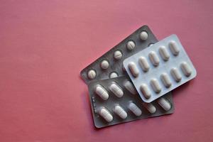 Various medications in white pills and capsules photo