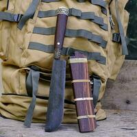 Knife with a backpack for survival in the forest photo