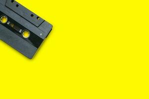 Vintage compact cassette tape on yellow background