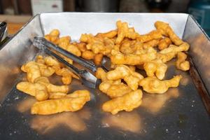 Thai Style Chinese Donut or Fried Bread Stick on Plate Preparing for Sale in Morning. Street Food Concept photo