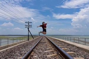 Adult woman Walking on RailRoad While Travel on Summer Vacation photo