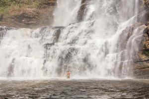 Bottom view of the waterfall known as Veu de Noiva along the trail in Indaia near Formosa, Goias, Brazil photo