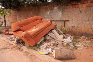 Planaltina, Goias, Brazil May 7, 2022 Trash and junk piled up on the side of the road near a house a common occurrences throughout Brazil, due to lack of garbage pick up photo