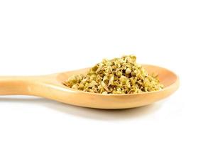 Oregano on the wooden spoon photo