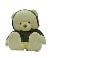 Teddy bear sitting listening to music isolated on a white background. photo