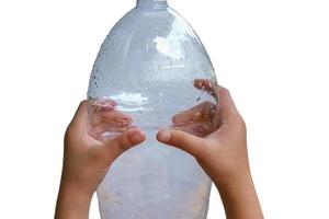 Girl squeezing the plastic bottles photo