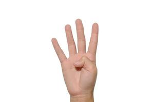 Boy raising four fingers up on hand on white background. photo