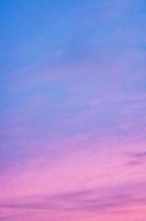 Bright colored clouds on dramatic sunset sky vertical background. photo