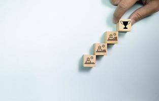 Top view wooden blocks set to step with working people to trophy. Concept for work hard and success career. photo