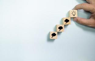 Top view wooden blocks set to step from thinking to idea. Concept for creative and design thinking. photo