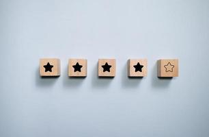 Top view wooden blocks with star rating graphic. Concept for rating and customer satisfaction. photo