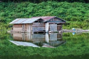 Wooden house on the river at Thailand photo