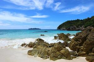 The blue sea and sky with mountain and rock photo