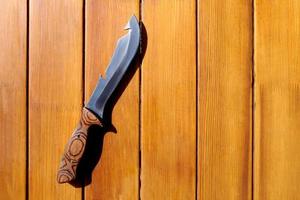 Camp knife for cooking on a wooden table photo