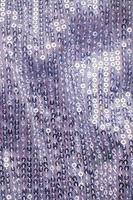 Pieces of cloth with silver sequins. Glitter background. Sequin texture photo