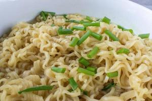 comfort food bowl of Ramen noodles with green onions photo