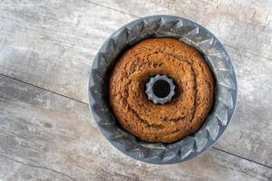 baked gingerbread cake in decorative mold baking pan flat lay photo