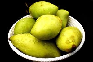 Closeup of Fresh Green Mangoes photo