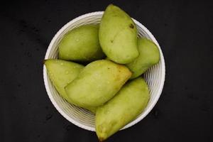 Green Mangoes in a basket photo