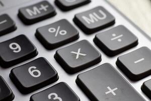Keyboard calculator close-up. Business concept of economy finance loan collateral mortgage loan rates increase. photo