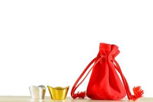 Red gift bag, gold and silver on a wooden floor photo