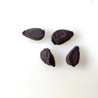 Macro shot of Nigella Seeds, Kalonji on white background. photo