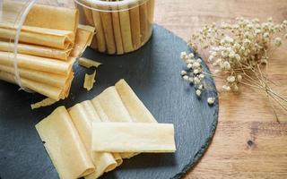 Curry puff pastry in a stone plate placed on a wooden table. photo