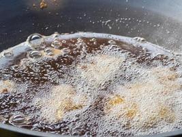 Boiling oil in frying pan for cooking photo