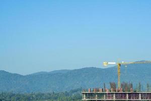 Construction site with crane on sky and cloudy background photo