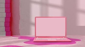 Pink laptop with decoration minimal. Shadow from tree and window on cement floor. photo