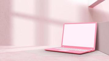 Pink laptop with decoration minimal. Shadow from window on cement floor. Mock-up computer. photo