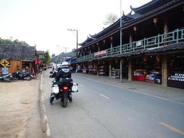 Rak Thai Village, Mae Hong Son, Thailand, February 14, 2019. Pictures of tourists riding motorcycles to Rak Thai village. photo