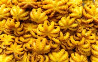 Lots of yellow fried squid photo