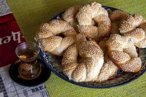 Turkish cuisine simits with sesame and tea. photo