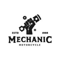Vintage logo mechanic monochrome motorcycle label with hand holding engine piston in circle isolated vector illustration