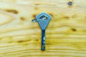 Master key on a wooden background. photo