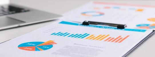 analyzing company's financial balance sheet working with digital augmented reality graphics. Businessman calculates financial data for long-term investment. photo