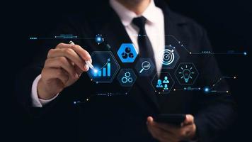 concept of long-term business development and management Executives looking at virtual screens business graph icon Goal setting, problem-solving, workflows, optimal business operations and innovation. photo