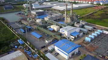 Aerial view of gas turbine power plant factory with cooling system fan in operation that producing electricity while causing pollution and releasing carbon dioxide which cause global warming video