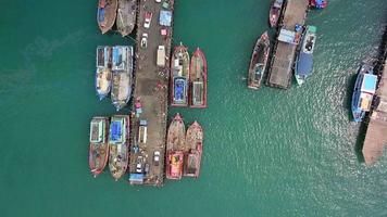 Aerial view of fisherman dock which has many fishing ships anchoring for transport seafood and supplies inland video