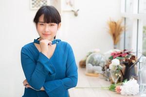 Beautiful portrait young asian woman smiling sitting at cafe, model girl happy with relax and resting looking camera, lifestyle concept. photo