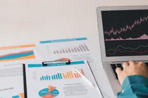 Businessman analyzing company's financial balance sheet working with digital augmented reality graphics. Businessman calculates financial data for long-term investment. photo