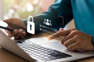 Cybersecurity and privacy concepts to protect data. Lock icon and internet network security technology. Businessmen protecting personal data on laptops and virtual interfaces. photo