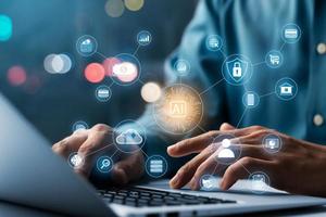 AI and IoT concepts of business, businessman working on a laptop computer for artificial intelligence polygon brain with icons of smart city Internet of Things, AI concept and IoT business. photo