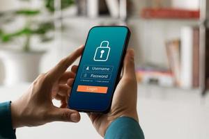 Cybersecurity internet and networking concept. Close up of hand holding smartphone information security and encryption, secure access to user's personal information, secure Internet access. photo