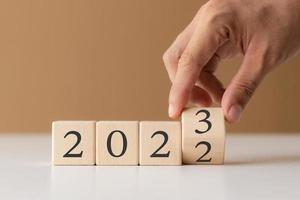 2023 new year goal planning idea, wood block cube with new year 2023 and target icon, business vision. photo