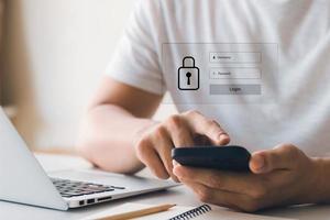 Concept Internet security and cyber network. businessman's hand works with a key icon virtual screen a cell phone on a computer, laptop, and a digital tablet. photo