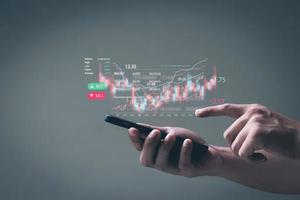 Businessmen work with stock market investments using smartphone to analyze trading data. is showing a growing virtual hologram stock. Financial stock market. photo