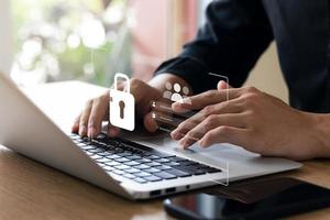 Cybersecurity and privacy concepts to protect data. Lock icon and internet network security technology. Businessmen protecting personal data on laptops and virtual interfaces. photo